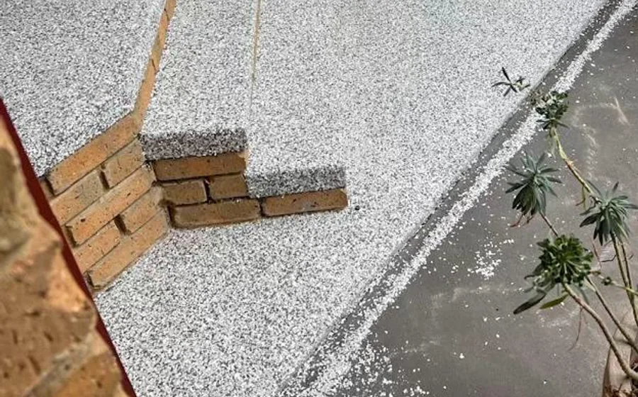 A resurfaced driveway with a flake-epoxy finish and a paver border