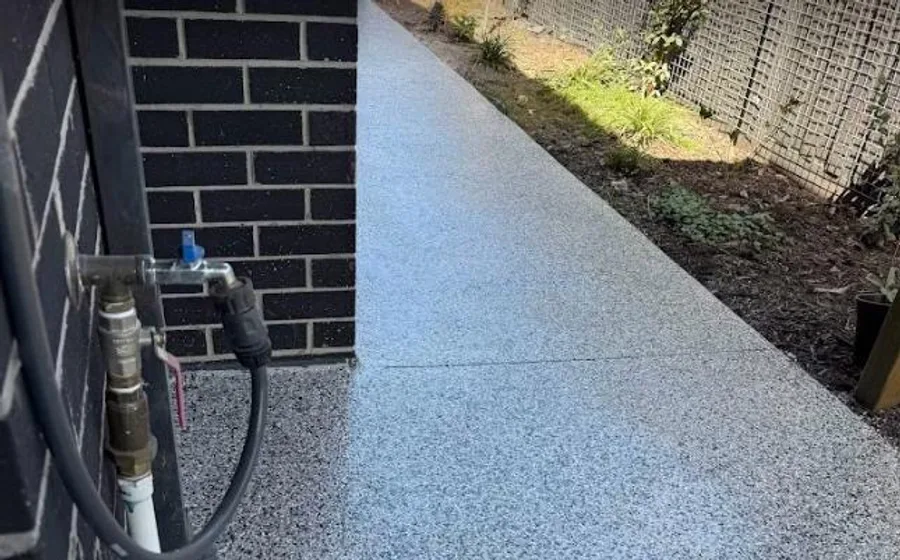 A flake-epoxy pathway running alongside a home