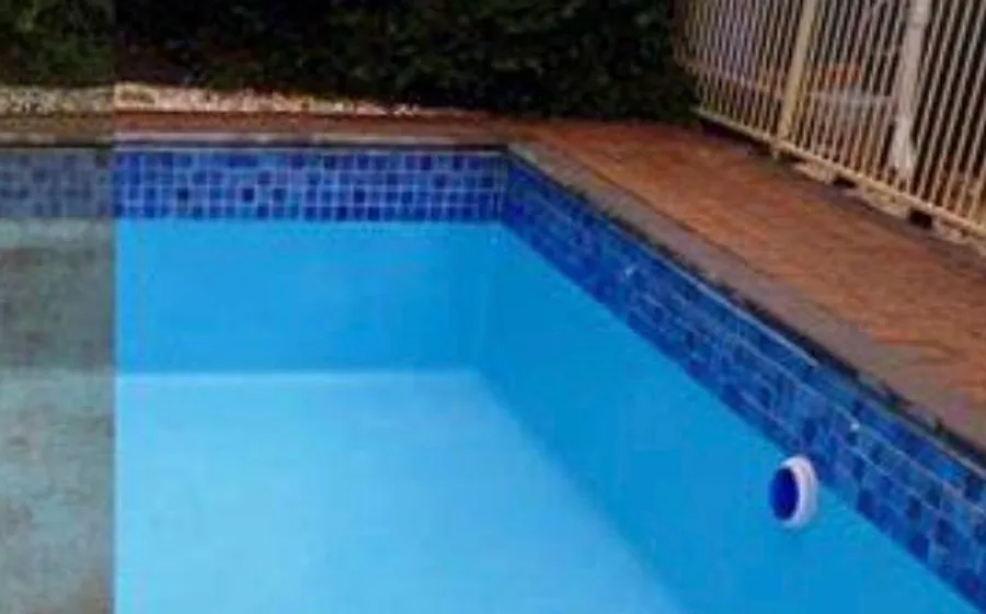 A tiled swimming pool with a resurfaced surround